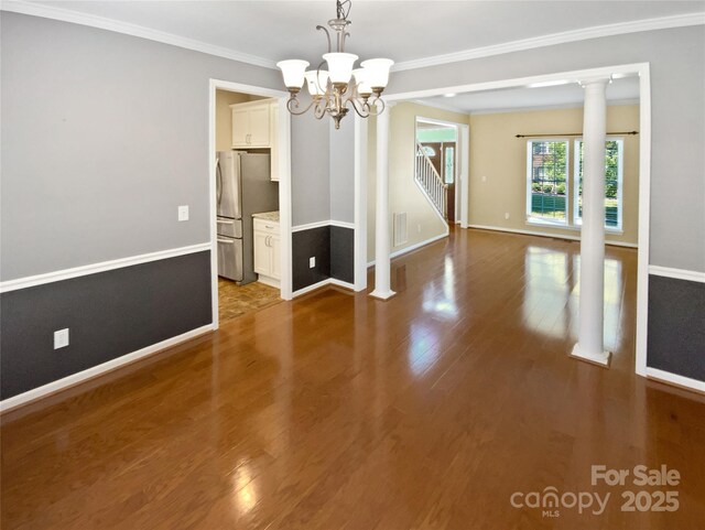 903 Furman Ct, Fort Mill, SC 29708 - unfurnished dining area featuring wood finished floors, a chandelier, baseboards, crown molding, and stairway