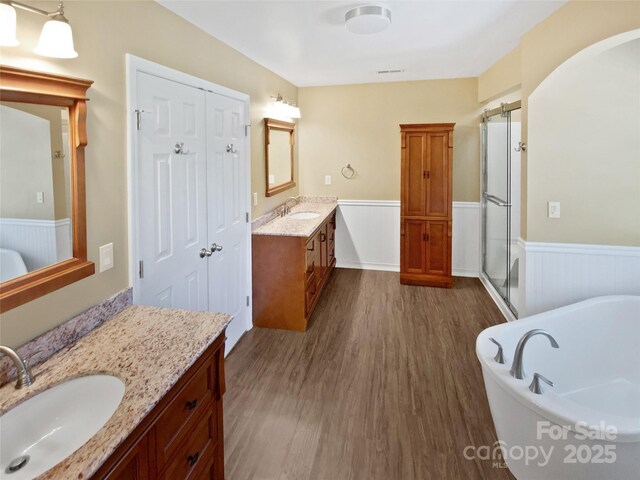 903 Furman Ct, Fort Mill, SC 29708 - full bath with a wainscoted wall, wood finished floors, a shower stall, a freestanding tub, and two vanities