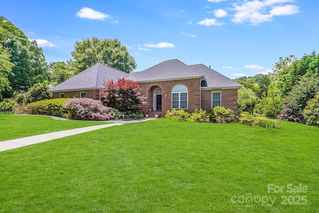 1337 Braeburn Rd NW, Concord, NC 28027 - traditional-style house with brick siding, a front lawn, and roof with shingles