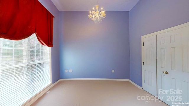 1337 Braeburn Rd NW, Concord, NC 28027 - unfurnished room with a chandelier, light carpet, plenty of natural light, and baseboards