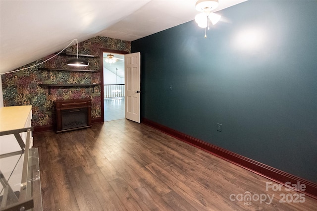 37 Geneva Cir Unit 1/2, Franklin, NC 28734 - unfurnished living room featuring wood finished floors, lofted ceiling, ceiling fan, and a large fireplace