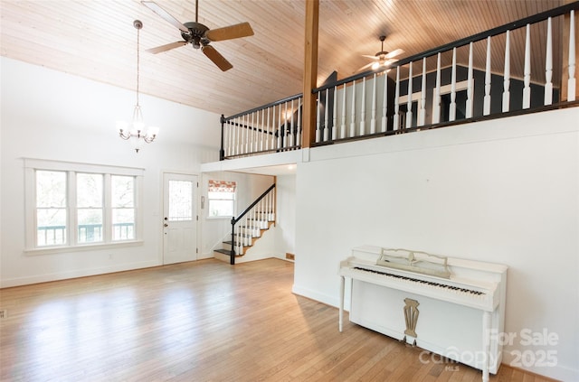 37 Geneva Cir Unit 1/2, Franklin, NC 28734 - unfurnished living room with a ceiling fan, high vaulted ceiling, stairs, wood finished floors, and a chandelier