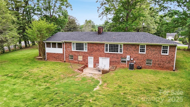200 Woodside Dr, Morganton, NC 28655 - back of property featuring central AC, a chimney, brick siding, and a lawn