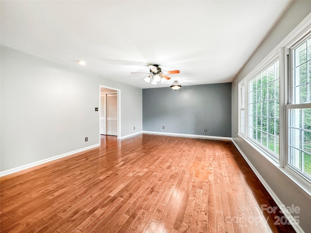200 Woodside Dr, Morganton, NC 28655 - empty room featuring baseboards, healthy amount of natural light, a ceiling fan, and light wood-style floors