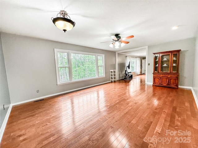 200 Woodside Dr, Morganton, NC 28655 - unfurnished living room featuring wood finished floors, a ceiling fan, and baseboards