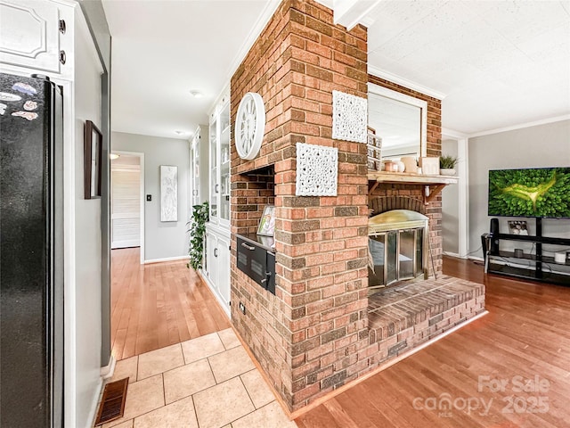 200 Woodside Dr, Morganton, NC 28655 - living area featuring a fireplace, baseboards, light wood finished floors, and crown molding