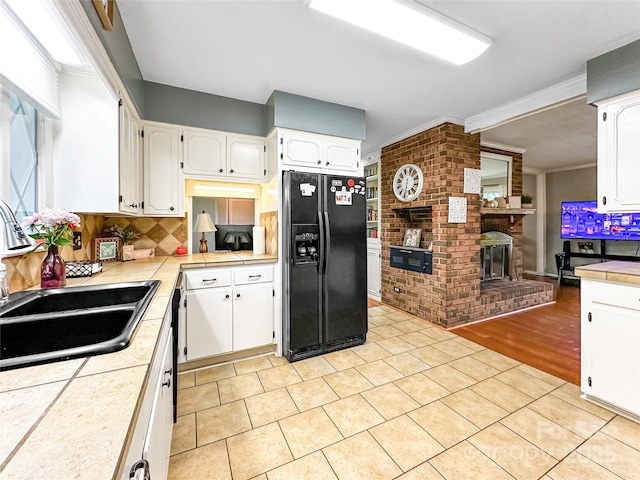 200 Woodside Dr, Morganton, NC 28655 - kitchen featuring black refrigerator with ice dispenser, a sink, white cabinets, tasteful backsplash, and light tile patterned floors