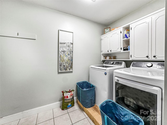 200 Woodside Dr, Morganton, NC 28655 - laundry room featuring cabinet space, washer and dryer, light tile patterned floors, and baseboards