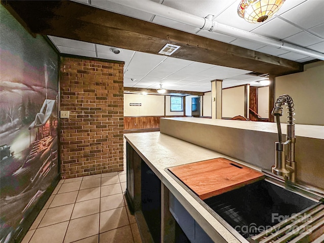 200 Woodside Dr, Morganton, NC 28655 - kitchen featuring a drop ceiling, tile patterned floors, a sink, a wainscoted wall, and wood walls