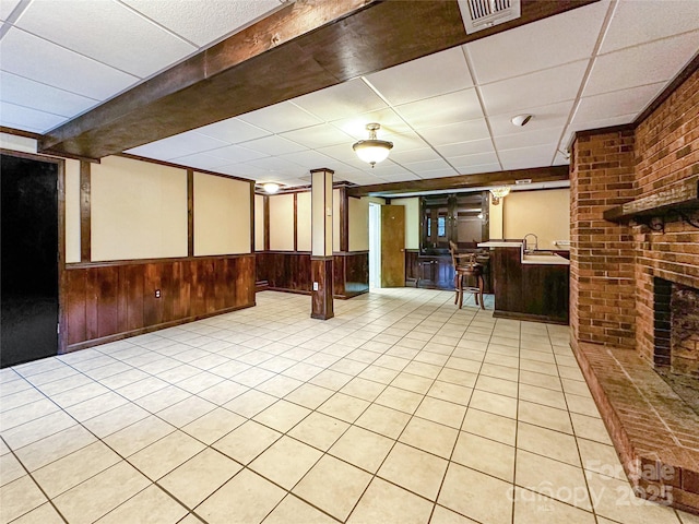 200 Woodside Dr, Morganton, NC 28655 - finished below grade area with a paneled ceiling, wood walls, a wainscoted wall, light tile patterned floors, and a sink