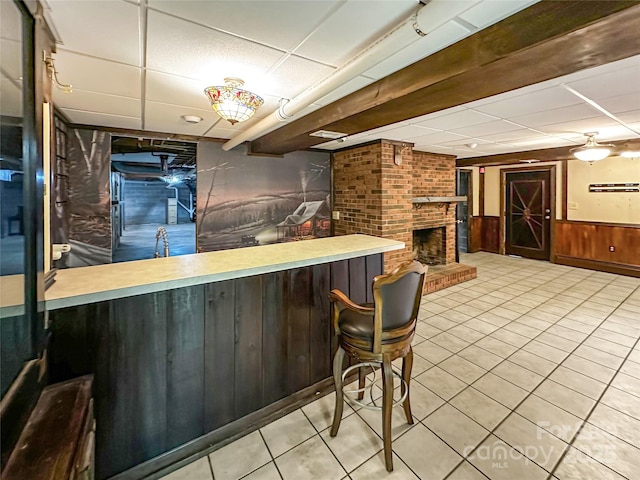 200 Woodside Dr, Morganton, NC 28655 - indoor bar featuring a drop ceiling, wainscoting, tile patterned flooring, wood walls, and a fireplace