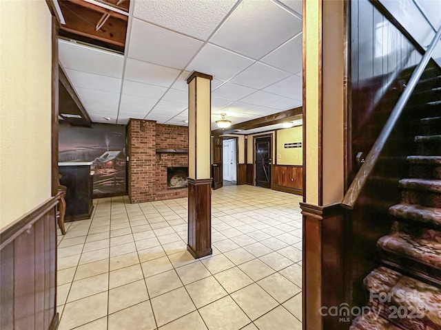 200 Woodside Dr, Morganton, NC 28655 - staircase featuring a brick fireplace, a wainscoted wall, a drop ceiling, and tile patterned floors