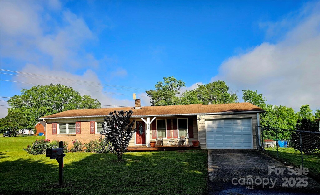 ranch-style house with a porch, a garage, asphalt driveway, and a chimney