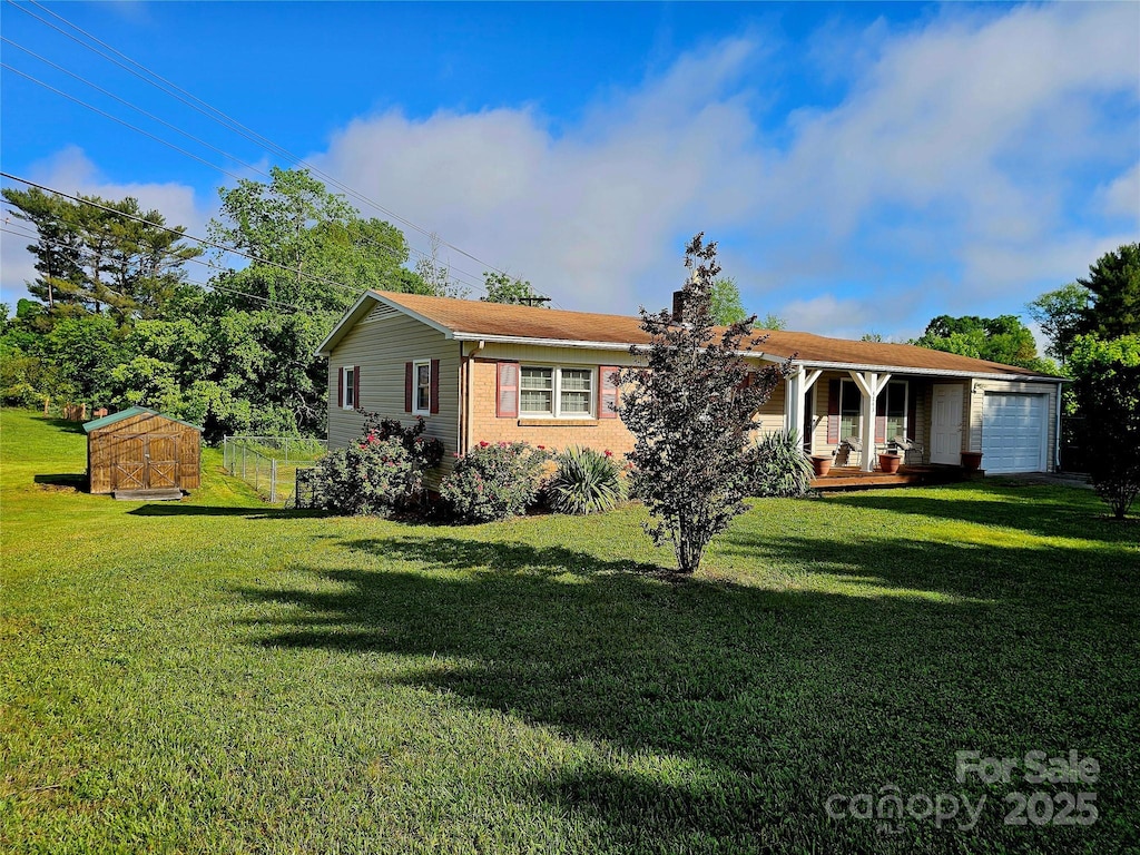 single story home with a shed, a front yard, a chimney, a garage, and covered porch