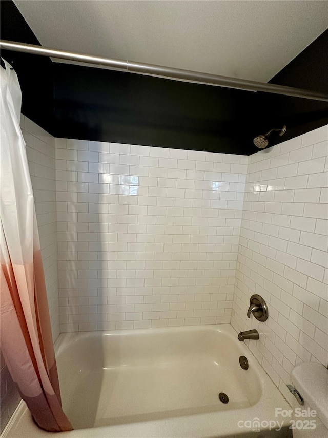 bathroom with shower / bath combo