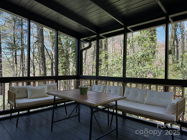 sunroom / solarium with an outdoor living space and healthy amount of natural light