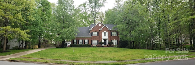 12314 Chickasaw Dr, Huntersville, NC 28078 - colonial home featuring a front lawn and brick siding