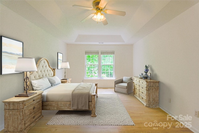 12314 Chickasaw Dr, Huntersville, NC 28078 - bedroom with light wood-style floors, a tray ceiling, and a ceiling fan