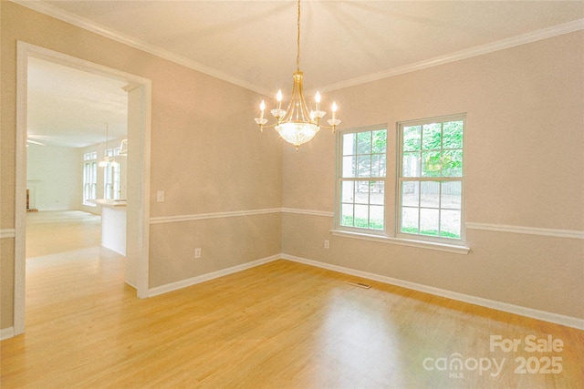 12314 Chickasaw Dr, Huntersville, NC 28078 - spare room featuring wood finished floors, a chandelier, baseboards, and ornamental molding
