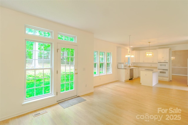 12314 Chickasaw Dr, Huntersville, NC 28078 - doorway featuring light wood-type flooring, a sink, and baseboards