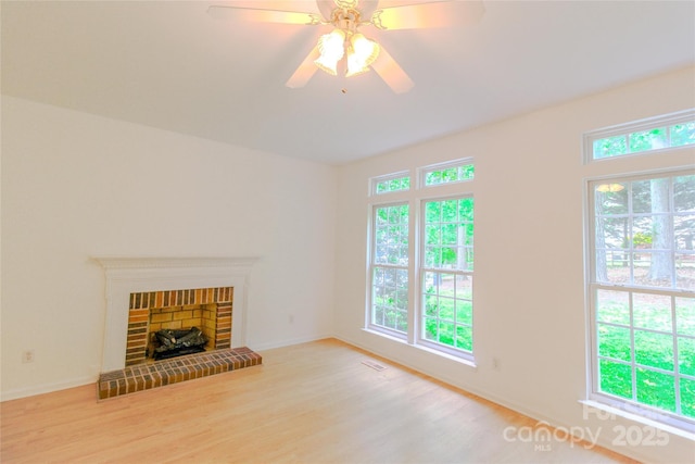 12314 Chickasaw Dr, Huntersville, NC 28078 - unfurnished living room featuring wood finished floors, a ceiling fan, baseboards, and a brick fireplace