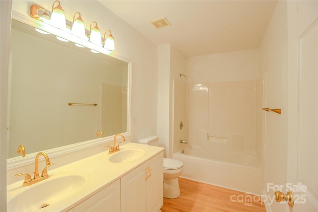 12314 Chickasaw Dr, Huntersville, NC 28078 - full bath featuring toilet, double vanity, wood finished floors, and bathing tub / shower combination