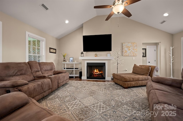 105 Kingston Pl, Spindale, NC 28160 - living area with ceiling fan, vaulted ceiling, a lit fireplace, recessed lighting, and wood finished floors