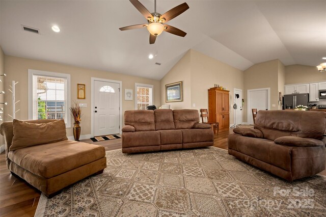 105 Kingston Pl, Spindale, NC 28160 - living room with light wood-type flooring, ceiling fan, vaulted ceiling, a chandelier, and baseboards