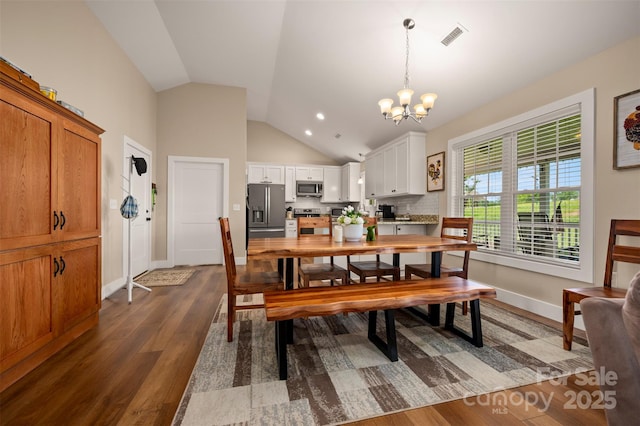 105 Kingston Pl, Spindale, NC 28160 - dining space with a chandelier, dark wood finished floors, baseboards, and high vaulted ceiling