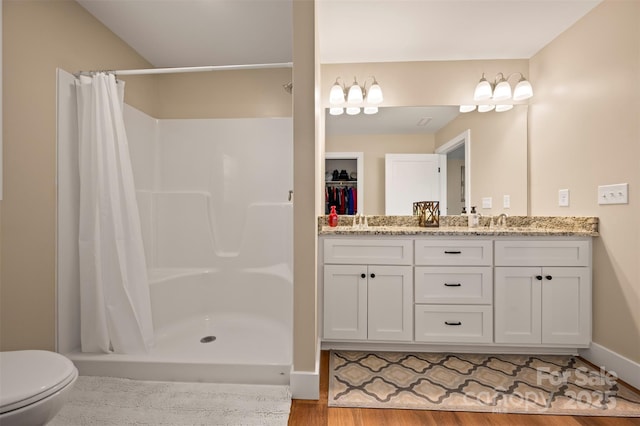 105 Kingston Pl, Spindale, NC 28160 - bathroom featuring a shower stall, vanity, wood finished floors, and toilet