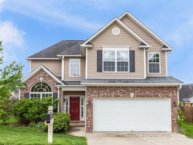 85 Lumber River Rd, Fletcher, NC 28732 - traditional home featuring a garage, driveway, brick siding, and roof with shingles