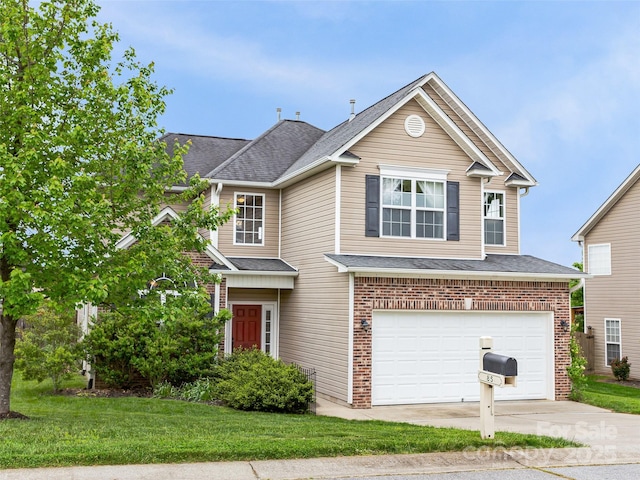 85 Lumber River Rd, Fletcher, NC 28732 - traditional-style home with a garage, driveway, brick siding, a shingled roof, and a front lawn