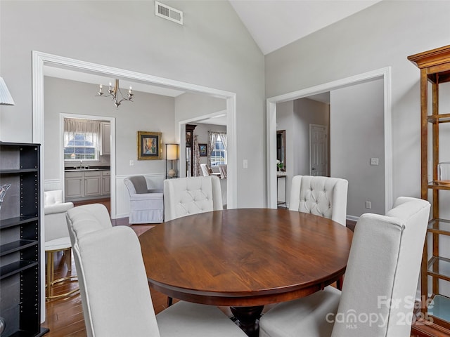 85 Lumber River Rd, Fletcher, NC 28732 - dining room with a chandelier, vaulted ceiling, and wood finished floors