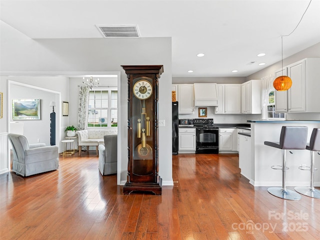 85 Lumber River Rd, Fletcher, NC 28732 - kitchen with black appliances, white cabinetry, a chandelier, dark wood finished floors, and dark countertops