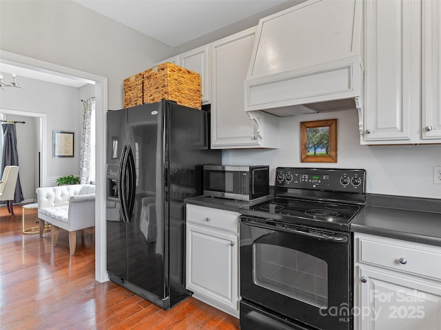 85 Lumber River Rd, Fletcher, NC 28732 - kitchen with black appliances, premium range hood, dark countertops, and white cabinetry
