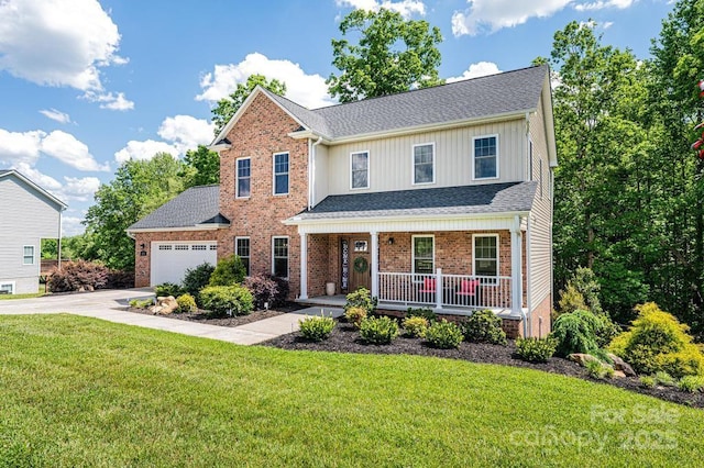 traditional home with covered porch, driveway, brick siding, a garage, and a front yard