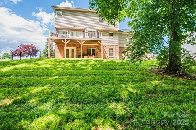 rear view of property with brick siding, a deck, and french doors