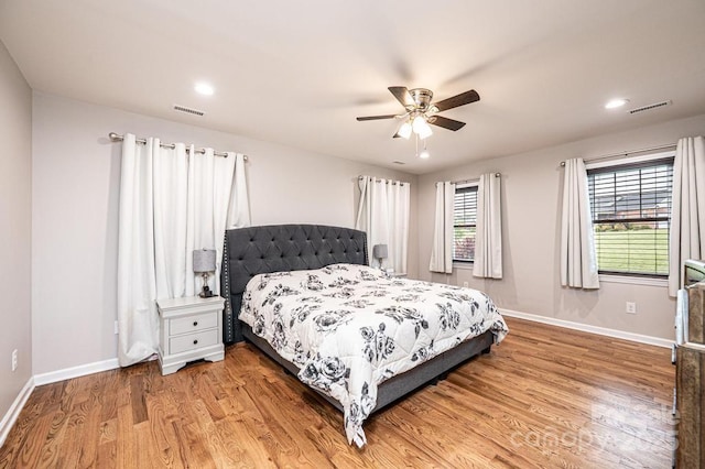 bedroom with light wood finished floors, baseboards, a ceiling fan, and recessed lighting