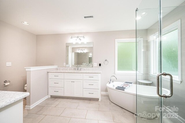 full bathroom featuring vanity, baseboards, a soaking tub, tile patterned floors, and recessed lighting