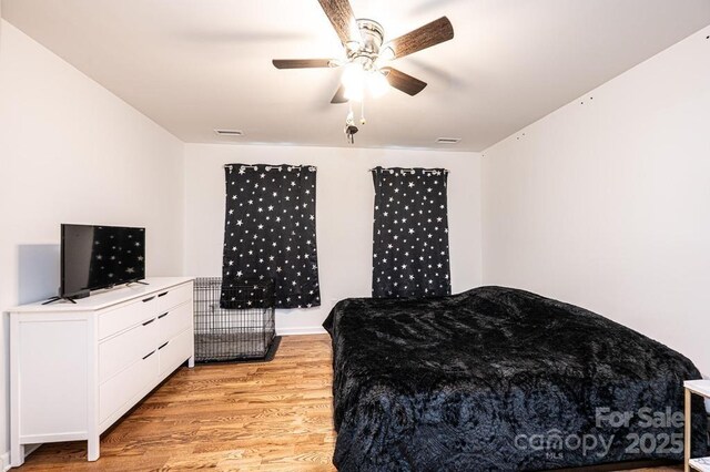 bedroom with light wood finished floors and a ceiling fan