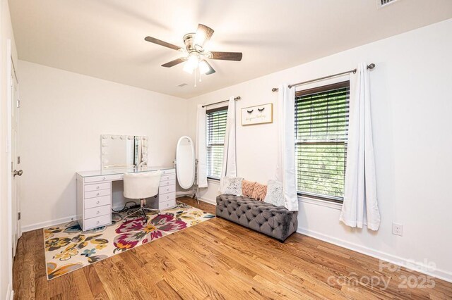 home office featuring wood finished floors, baseboards, and ceiling fan