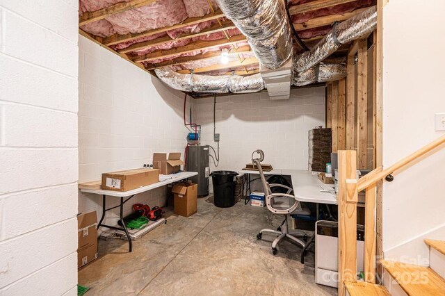 unfinished basement with electric water heater and concrete block wall