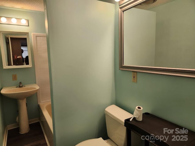 full bath featuring toilet and wood finished floors