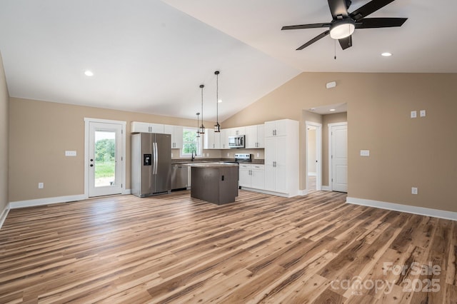 355 Northbrook Iii School Rd Unit 10, Vale, NC 28164 - kitchen featuring appliances with stainless steel finishes, open floor plan, white cabinets, a center island, and light wood-style flooring