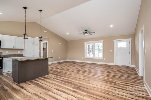 355 Northbrook Iii School Rd Unit 10, Vale, NC 28164 - kitchen featuring vaulted ceiling, a center island, light wood finished floors, ceiling fan, and white cabinetry