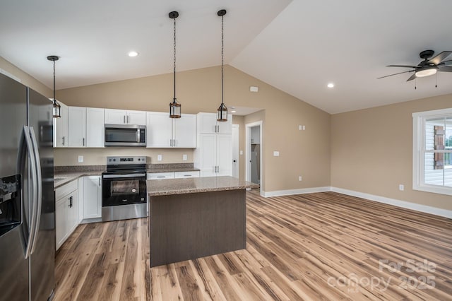 355 Northbrook Iii School Rd Unit 10, Vale, NC 28164 - kitchen featuring stainless steel appliances, a center island, light wood finished floors, vaulted ceiling, and white cabinetry