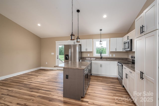 355 Northbrook Iii School Rd Unit 10, Vale, NC 28164 - kitchen with appliances with stainless steel finishes, a center island, light wood-style flooring, lofted ceiling, and white cabinetry