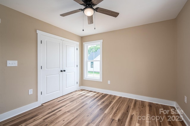 355 Northbrook Iii School Rd Unit 10, Vale, NC 28164 - unfurnished bedroom with baseboards, wood finished floors, a closet, and ceiling fan