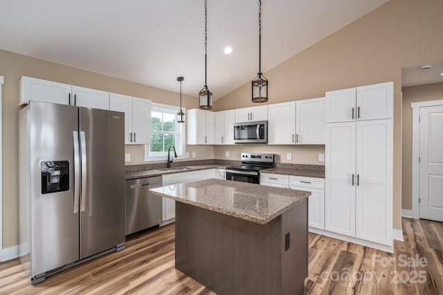 355 Northbrook Iii School Rd Unit 10, Vale, NC 28164 - kitchen featuring stainless steel appliances, a sink, light wood-type flooring, a kitchen island, and decorative light fixtures