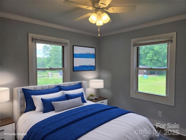 bedroom with multiple windows, ornamental molding, and a ceiling fan